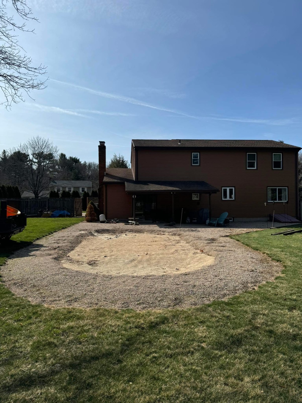 Bare circular area in a backyard before restoration
